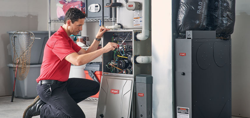 Bloch-FurnaceRepair HVAC technician repairing a furnace system